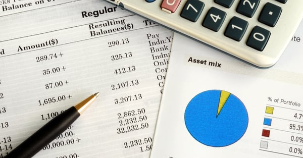 image of an investment portfolio, account statement, pen, and calculator